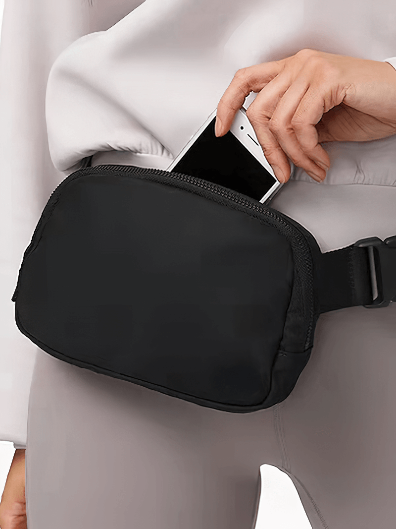 Person using Fashion Sports Multi-function Waist Bag SF1511 with phone in pocket, ideal for running and sports, unisex design, durable nylon